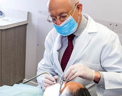 Dr. Rosenson Working on a Patient's Teeth